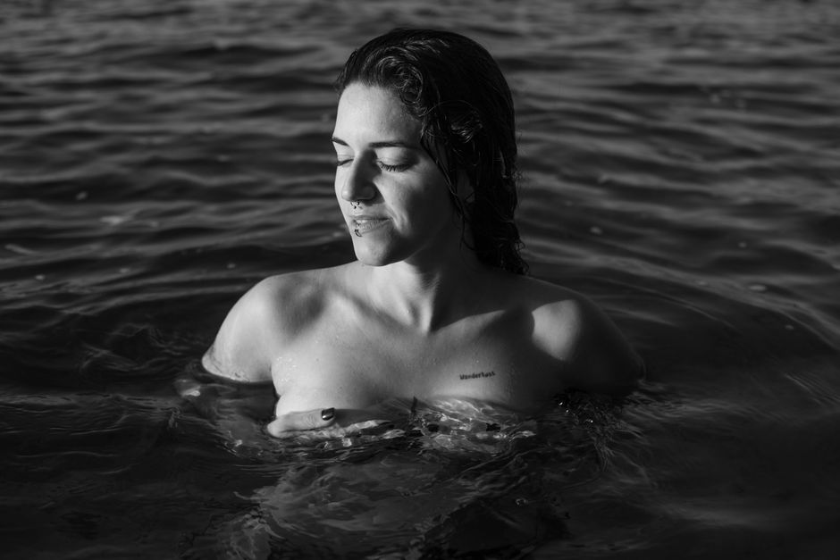 Tranquil black and white portrait of a woman in water, capturing serene beauty.