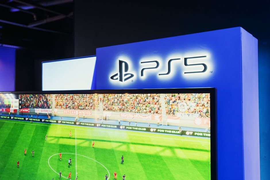 PS5 gaming station featuring a live soccer match onscreen, showcasing high-quality graphics.