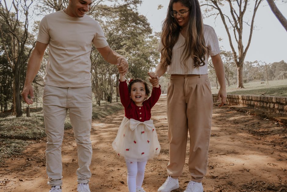 Happy family moment strolling through a park in São Paulo, capturing joy and connection.