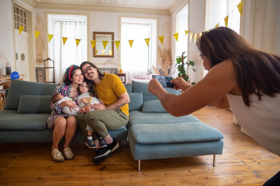 Family enjoying a moment together as a photo is taken in a cozy home setting.