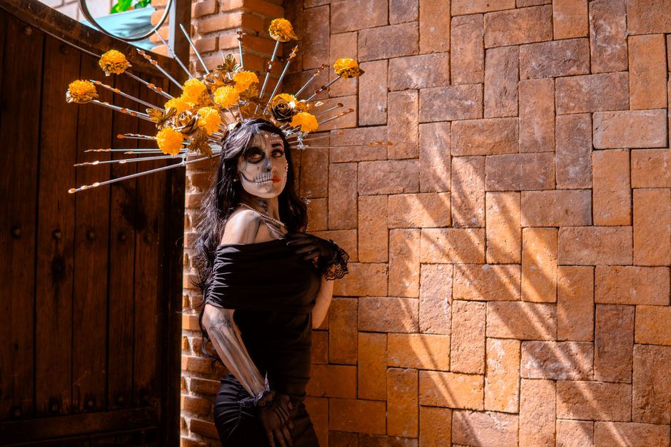 Elegant Catrina makeup and floral headdress in Mexico City for Day of the Dead.