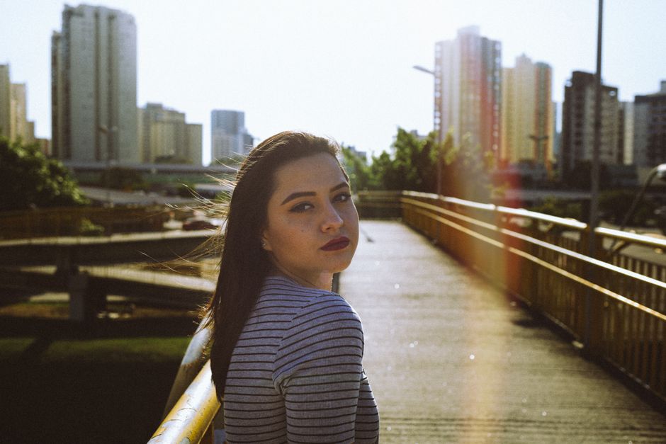 Captivating portrait of a woman with red lips on a bridge in São José dos Campos, Brazil.