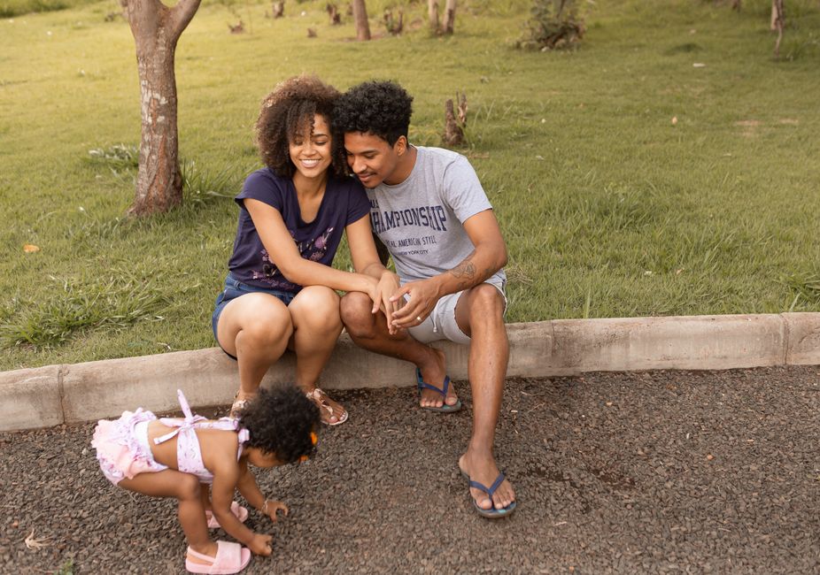 A joyful family enjoys quality time together outdoors on a sunny day at the park.